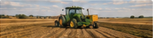 Related-article thumbnail of a green tractor working a harvested field.
