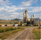 Related-story thumbnail of a farm grain elevator and agricultural buildings in a field.